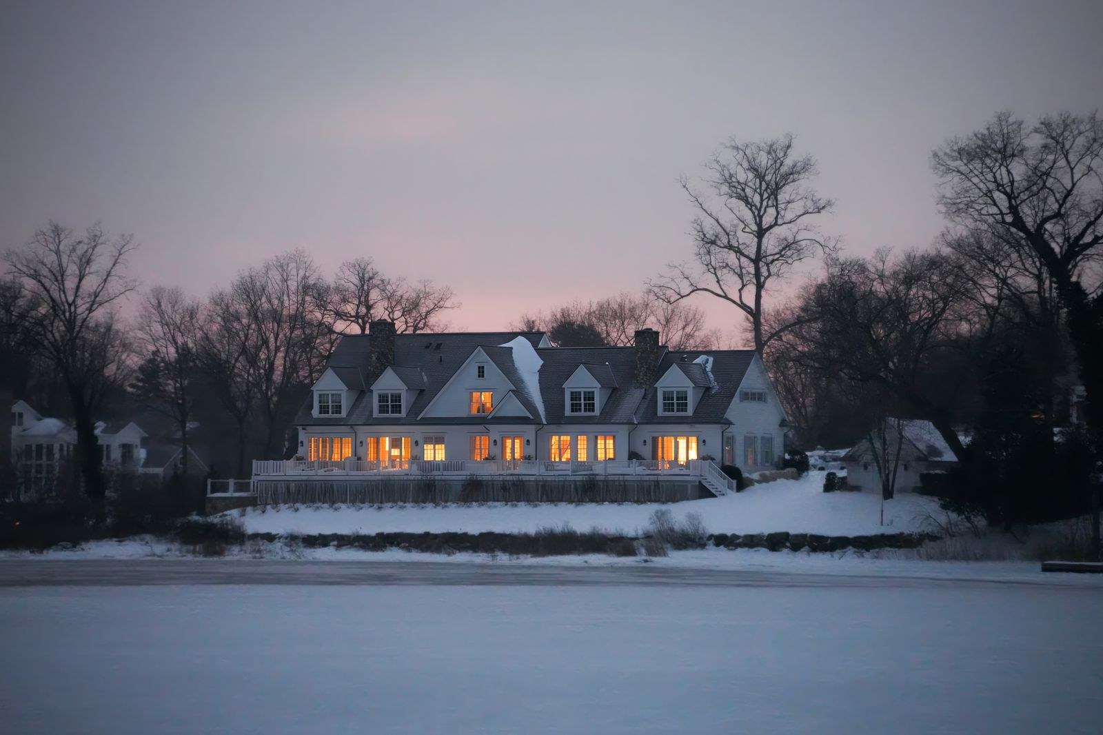 lit home surrounded by snow during a winter claim scenario