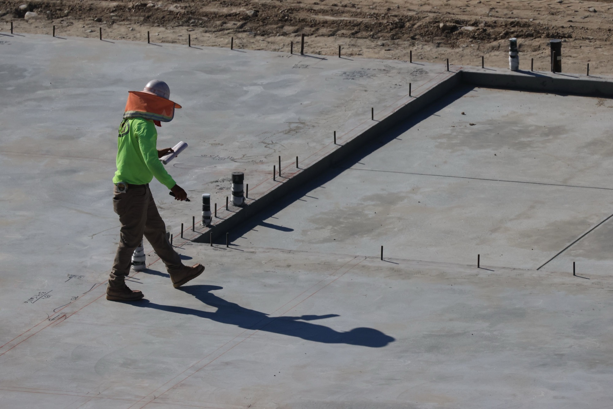 inspector reviewing a concrete slab before leveling